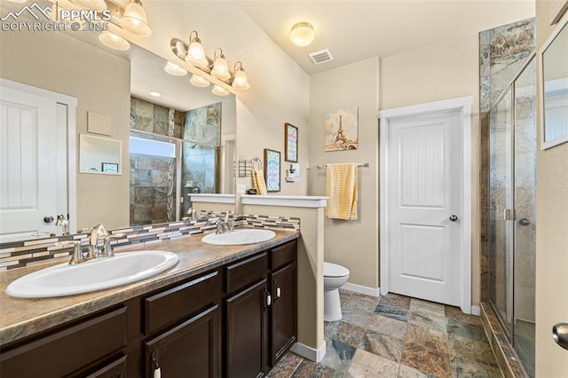 7814 Dry Willow Way, Colorado Springs, CO 80908 - bathroom featuring a shower stall, double vanity, a sink, and visible vents