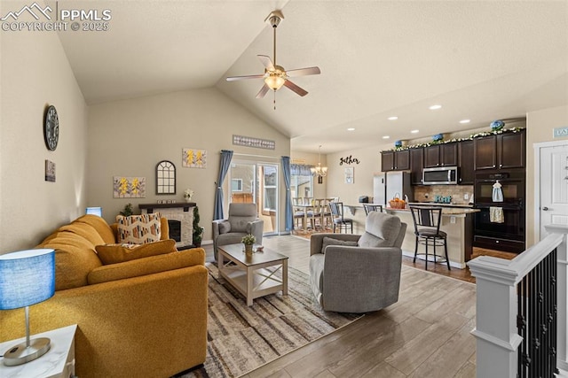 7814 Dry Willow Way, Colorado Springs, CO 80908 - living room with high vaulted ceiling, recessed lighting, light wood-type flooring, and ceiling fan with notable chandelier
