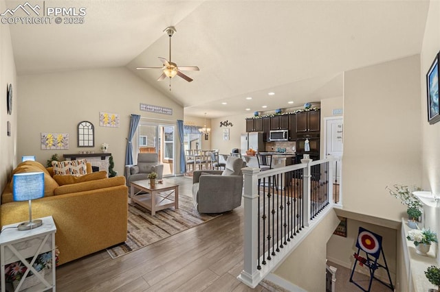 7814 Dry Willow Way, Colorado Springs, CO 80908 - living room with light wood-type flooring, ceiling fan with notable chandelier, lofted ceiling, and recessed lighting