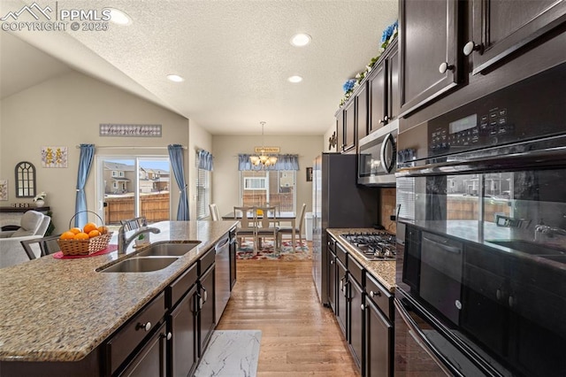 7814 Dry Willow Way, Colorado Springs, CO 80908 - kitchen featuring an inviting chandelier, a sink, stainless steel appliances, light wood-style flooring, and light stone counters