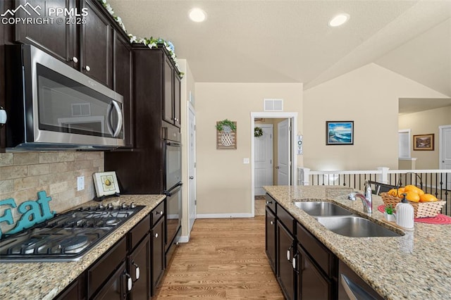 7814 Dry Willow Way, Colorado Springs, CO 80908 - kitchen with tasteful backsplash, baseboards, a sink, light wood-type flooring, and stainless steel appliances