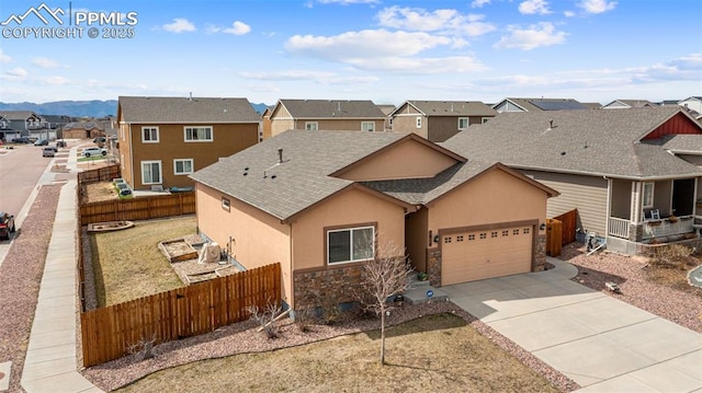 7814 Dry Willow Way, Colorado Springs, CO 80908 - view of front of home featuring concrete driveway, a residential view, fence private yard, stucco siding, and a garage