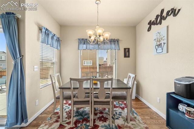 7814 Dry Willow Way, Colorado Springs, CO 80908 - dining room featuring baseboards, an inviting chandelier, and wood finished floors