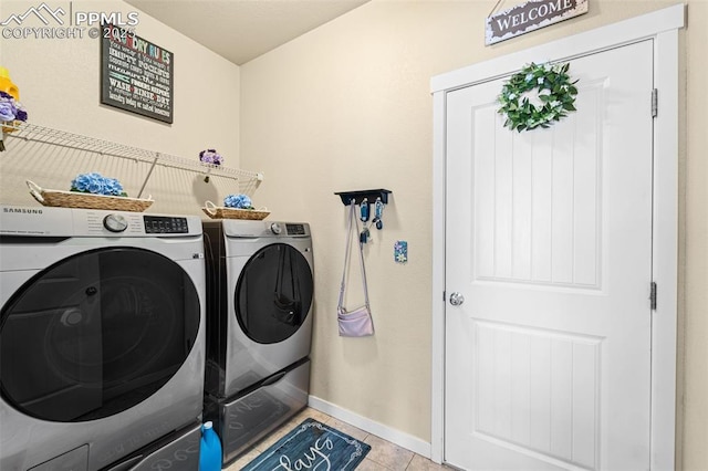 7814 Dry Willow Way, Colorado Springs, CO 80908 - laundry room with washer and clothes dryer, laundry area, baseboards, and light tile patterned flooring