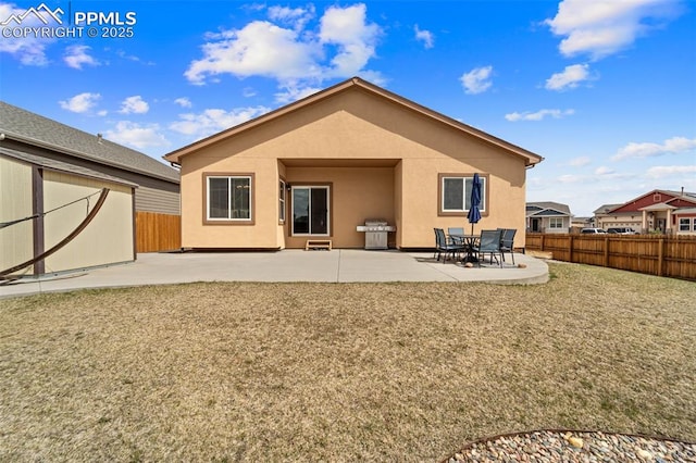 7814 Dry Willow Way, Colorado Springs, CO 80908 - rear view of house with a patio area, a fenced backyard, a yard, and stucco siding