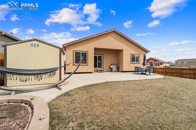 7814 Dry Willow Way, Colorado Springs, CO 80908 - rear view of property with a patio, stucco siding, an outdoor structure, a storage shed, and fence