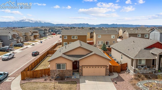 7814 Dry Willow Way, Colorado Springs, CO 80908 - view of front of house with fence, a residential view, a mountain view, and a garage