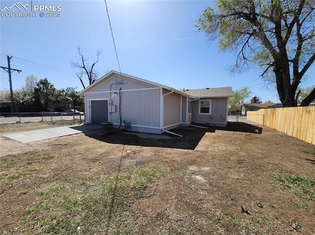 exterior space featuring fence, a garage, and concrete driveway
