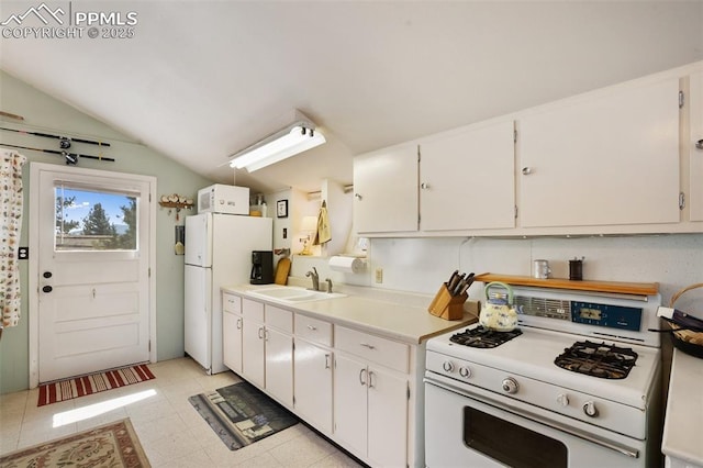 kitchen featuring a sink, vaulted ceiling, white cabinetry, white appliances, and light countertops