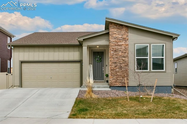 9843 Hidden Ranch Ct, Peyton, CO 80831 - view of front of house with an attached garage, driveway, a front yard, board and batten siding, and a shingled roof