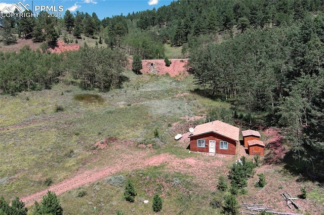 aerial view featuring a wooded view
