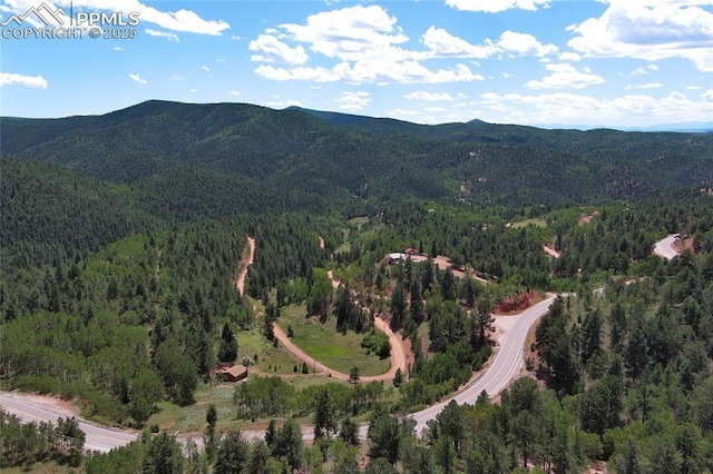 aerial view with a wooded view and a mountain view