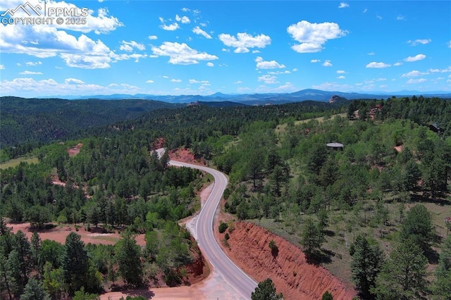 aerial view with a wooded view and a mountain view