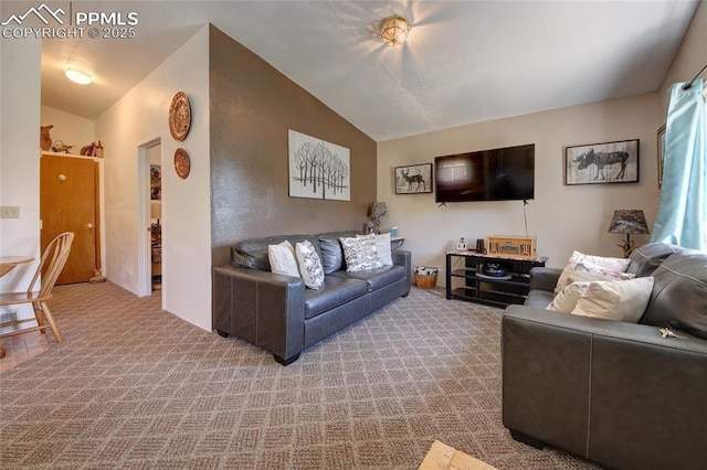 carpeted living room featuring lofted ceiling
