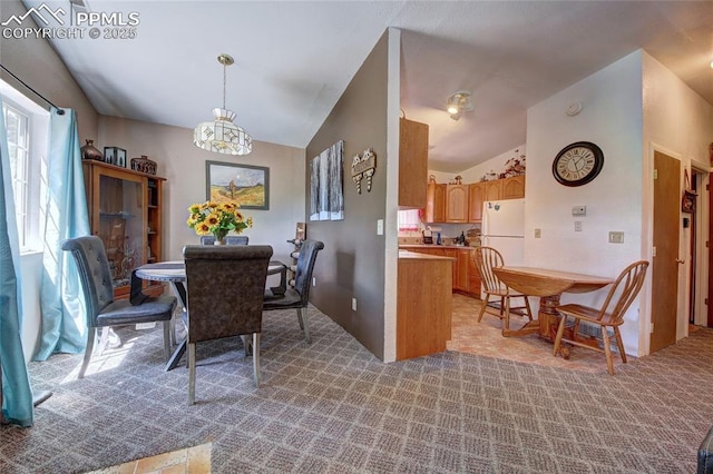 dining room with light carpet and lofted ceiling