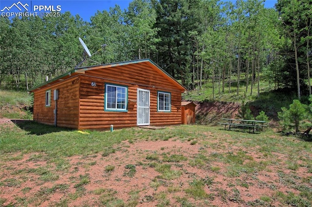 exterior space with log veneer siding