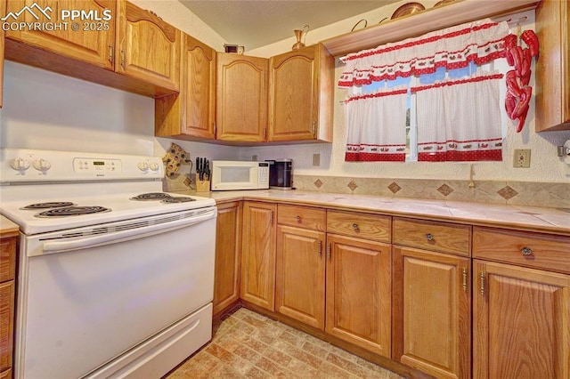 kitchen featuring brown cabinets, tile countertops, and white appliances