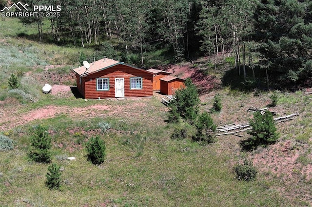 view of home's exterior featuring a wooded view