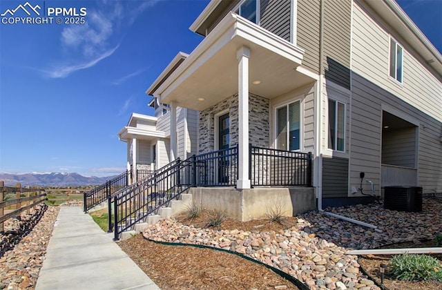 5033 Baseline Vw, Colorado Springs, CO 80920 - view of exterior entry with a porch, a mountain view, and central AC unit