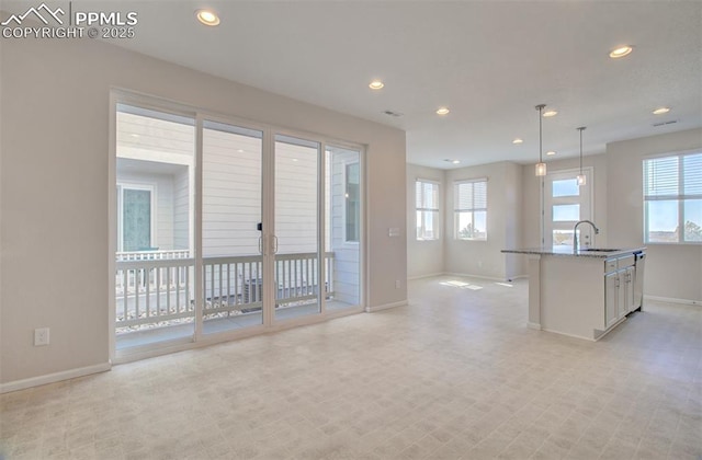 5033 Baseline Vw, Colorado Springs, CO 80920 - kitchen with a sink, baseboards, recessed lighting, healthy amount of natural light, and white cabinetry