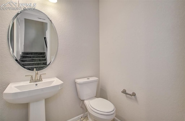 5033 Baseline Vw, Colorado Springs, CO 80920 - half bath featuring toilet, baseboards, and a sink
