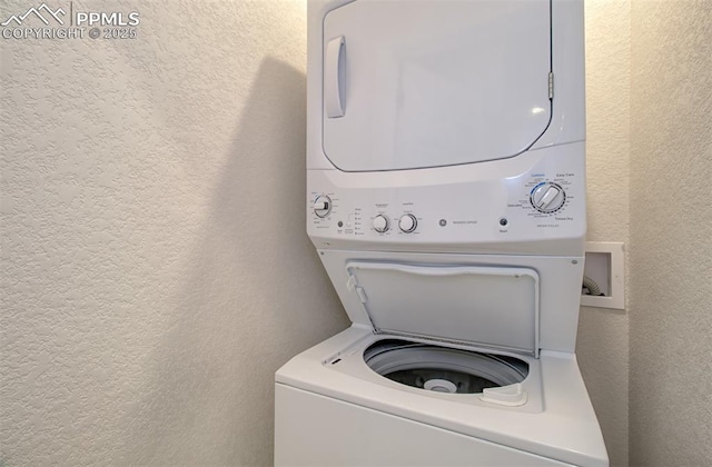 5033 Baseline Vw, Colorado Springs, CO 80920 - laundry area featuring stacked washer / dryer and a textured wall