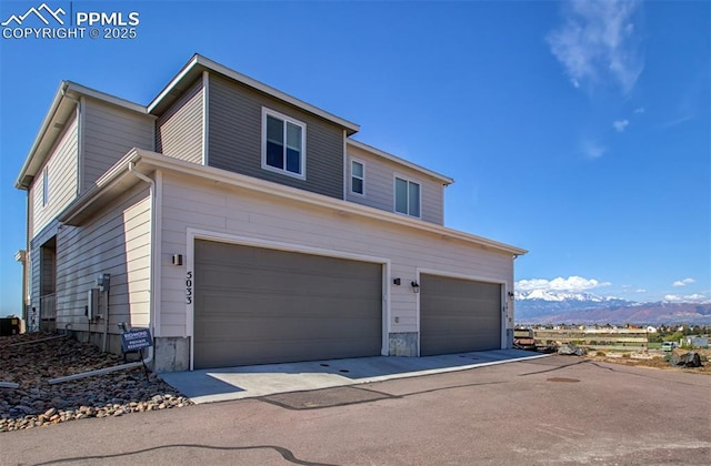 5033 Baseline Vw, Colorado Springs, CO 80920 - traditional home featuring a garage and a mountain view
