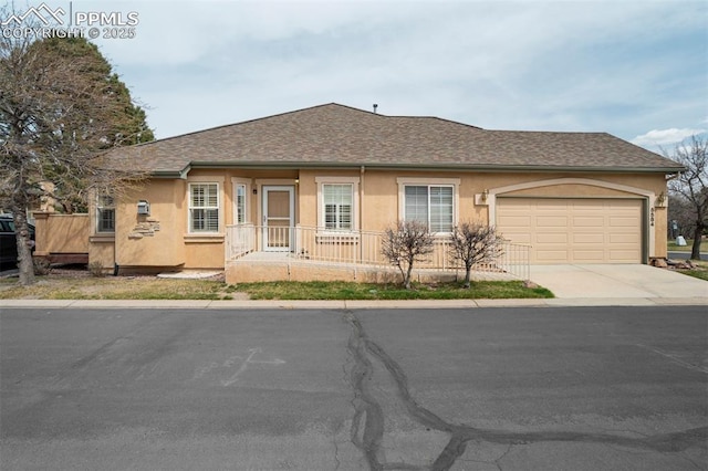 5584 Sonnet Hts, Colorado Springs, CO 80918 - view of front of house featuring concrete driveway, a shingled roof, a garage, and stucco siding