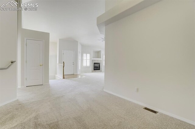 5584 Sonnet Hts, Colorado Springs, CO 80918 - carpeted spare room with baseboards, a glass covered fireplace, and visible vents