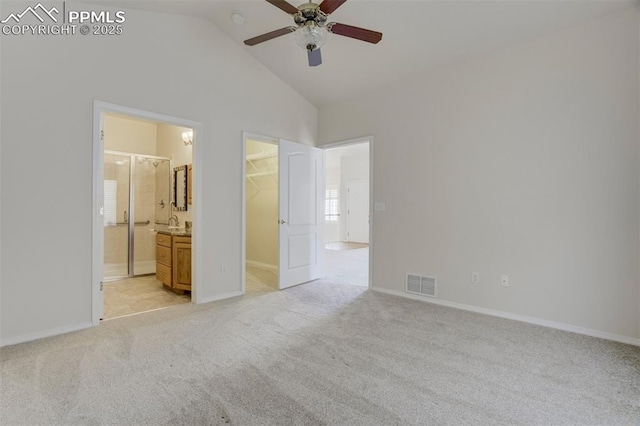 5584 Sonnet Hts, Colorado Springs, CO 80918 - unfurnished bedroom with a spacious closet, vaulted ceiling, visible vents, light carpet, and baseboards