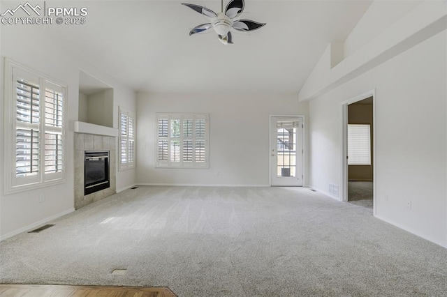 5584 Sonnet Hts, Colorado Springs, CO 80918 - unfurnished living room with a tile fireplace, baseboards, visible vents, ceiling fan, and carpet