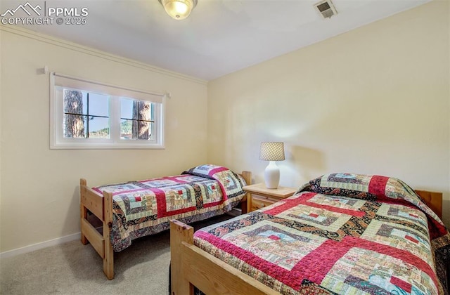 carpeted bedroom with baseboards and visible vents