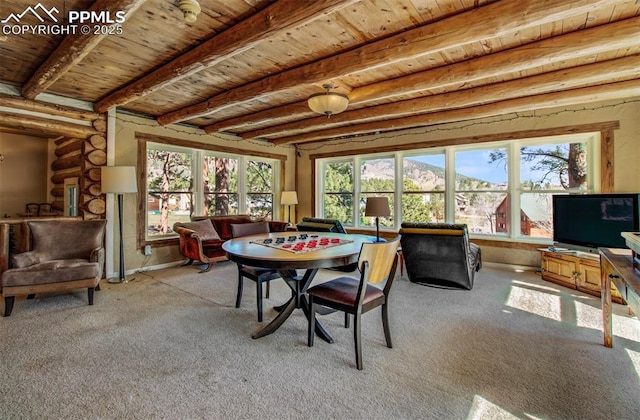 dining space featuring wood ceiling, carpet floors, and beamed ceiling