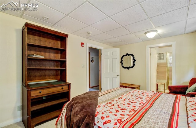 bedroom with a paneled ceiling and ensuite bathroom