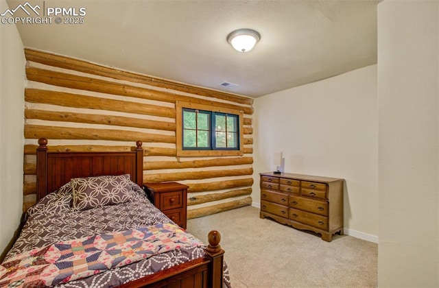 bedroom with baseboards, log walls, carpet flooring, and visible vents