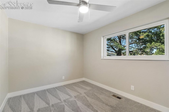 unfurnished room featuring carpet, visible vents, a ceiling fan, and baseboards