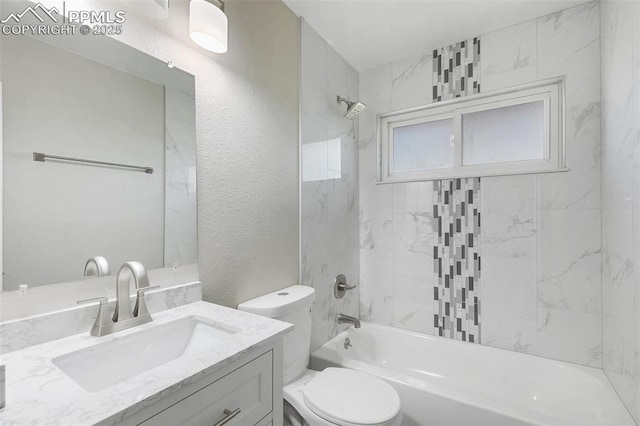 full bath featuring toilet, a textured wall, vanity, and shower / tub combination