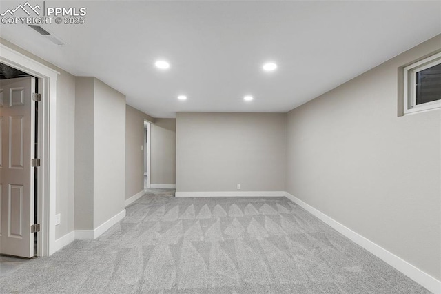 finished basement featuring light colored carpet, baseboards, visible vents, and recessed lighting