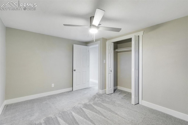 unfurnished bedroom with baseboards, carpet floors, a closet, and ceiling fan