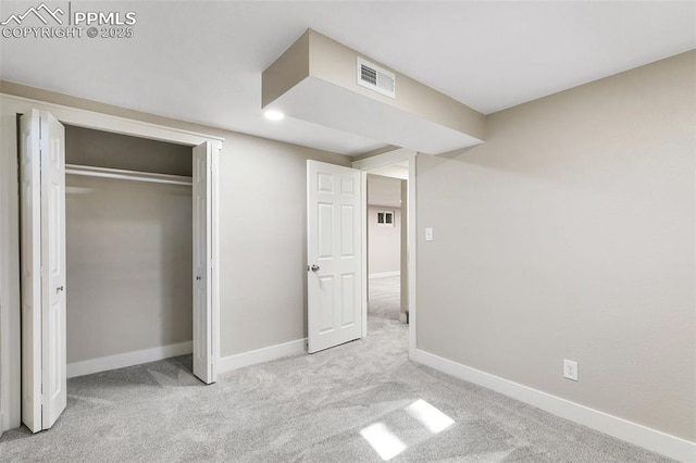 unfurnished bedroom featuring baseboards, visible vents, a closet, and carpet flooring