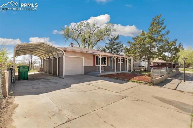 ranch-style home featuring concrete driveway, covered porch, a garage, brick siding, and a detached carport