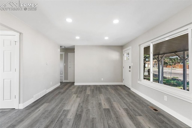 empty room with baseboards, wood finished floors, visible vents, and recessed lighting