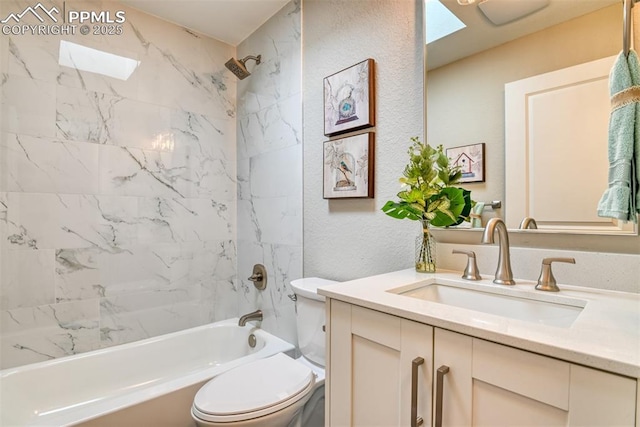 bathroom with a textured wall, bathing tub / shower combination, vanity, and toilet