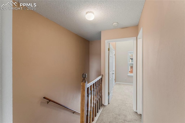 1951 Giltshire Dr, Colorado Springs, CO 80905 - corridor featuring a textured ceiling, baseboards, carpet, and an upstairs landing