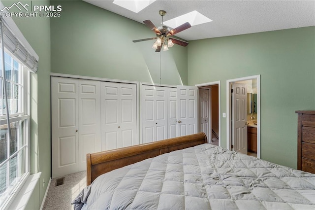 1951 Giltshire Dr, Colorado Springs, CO 80905 - bedroom featuring carpet flooring, visible vents, multiple closets, a skylight, and high vaulted ceiling