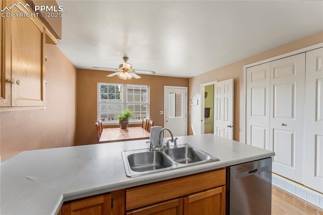 1951 Giltshire Dr, Colorado Springs, CO 80905 - kitchen with dishwasher, a sink, light countertops, ceiling fan, and brown cabinetry