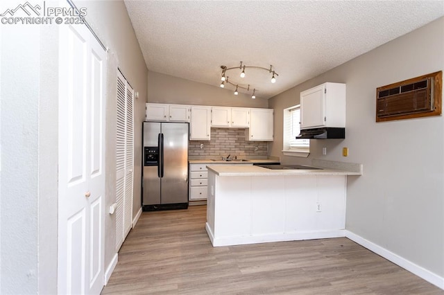 138 Hoedown Cir, Fountain, CO 80817 - kitchen with stainless steel fridge with ice dispenser, a peninsula, white cabinets, light countertops, and a wall mounted air conditioner