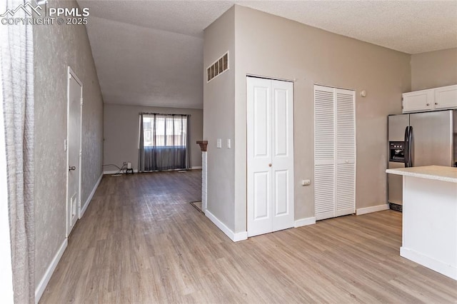 138 Hoedown Cir, Fountain, CO 80817 - hallway with light wood finished floors, visible vents, and baseboards