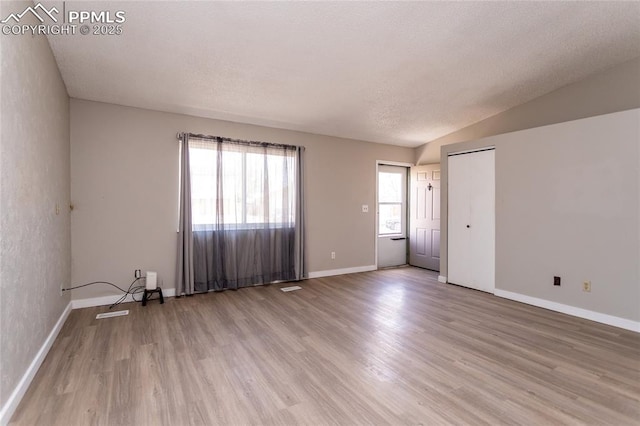 138 Hoedown Cir, Fountain, CO 80817 - unfurnished room featuring light wood-style flooring, plenty of natural light, baseboards, and lofted ceiling