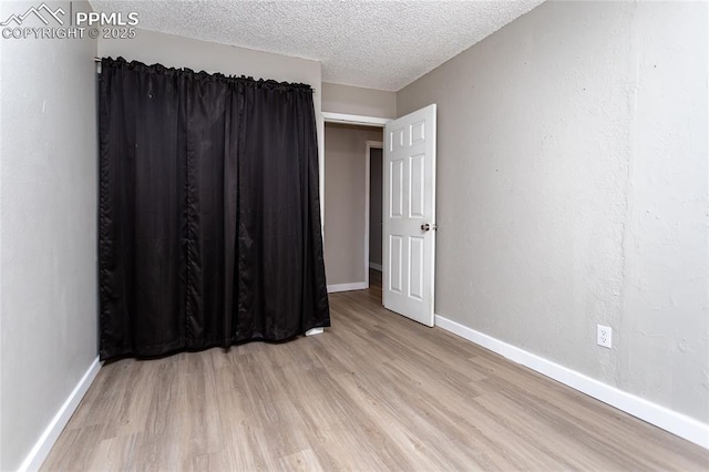 138 Hoedown Cir, Fountain, CO 80817 - spare room featuring baseboards, light wood-type flooring, and a textured ceiling